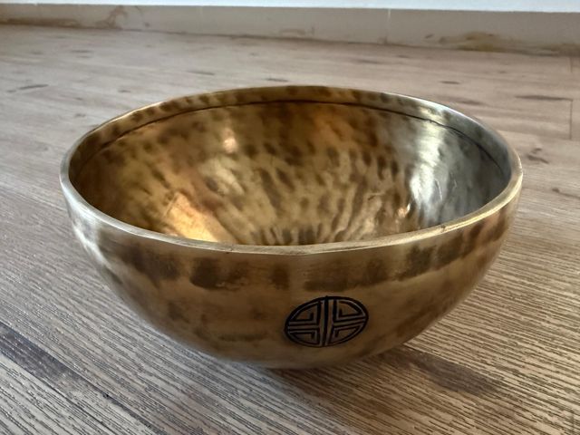 A hand-hammered AYA bowl with an engraved symbol